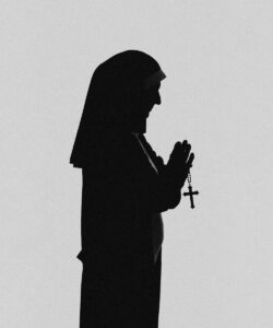 a silhouette of a person holding a rosary